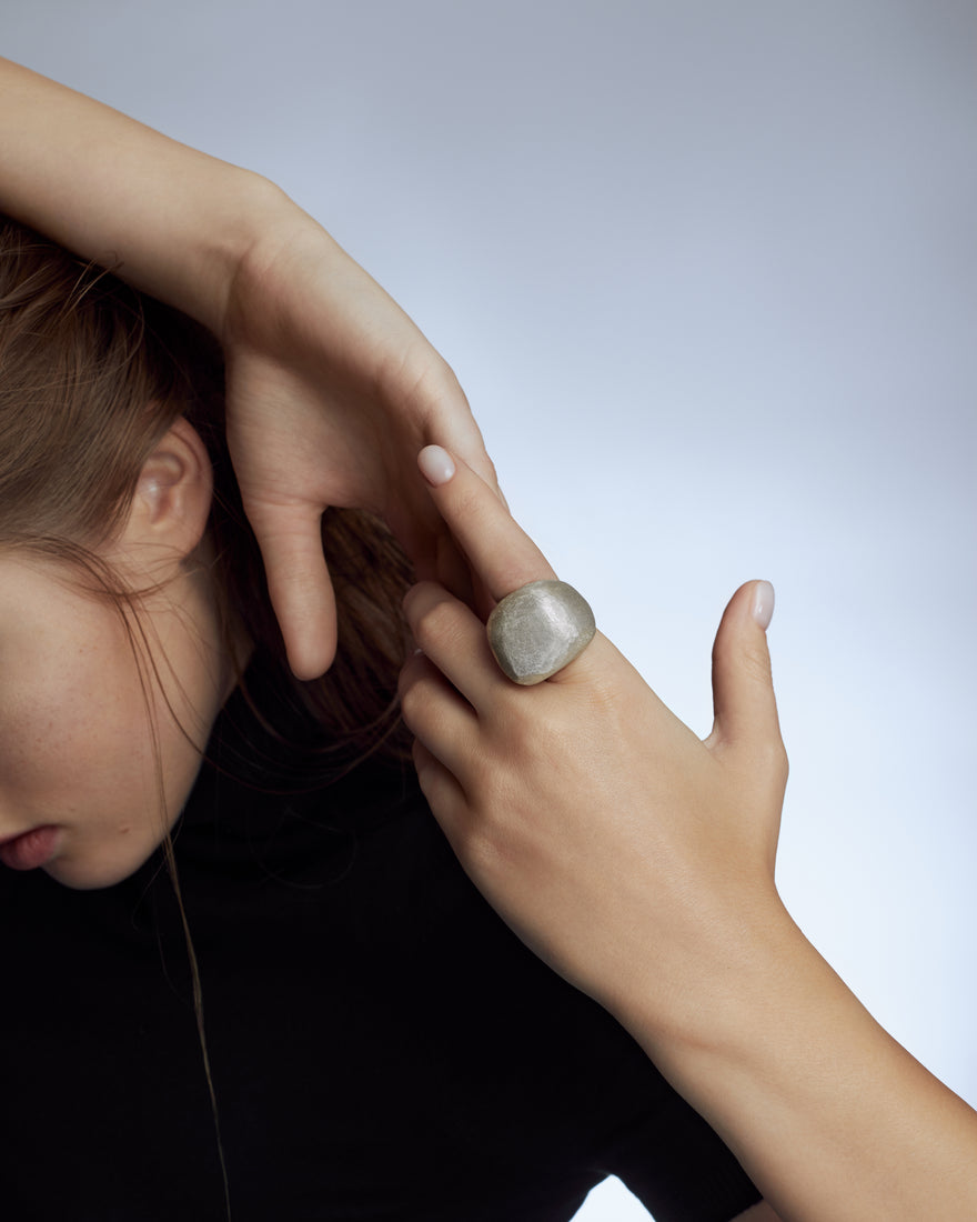 textured silver bombe ring on model's finger