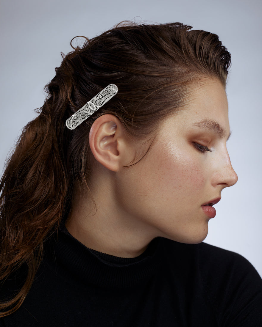 Silver filigree hair barrette in woman's hair